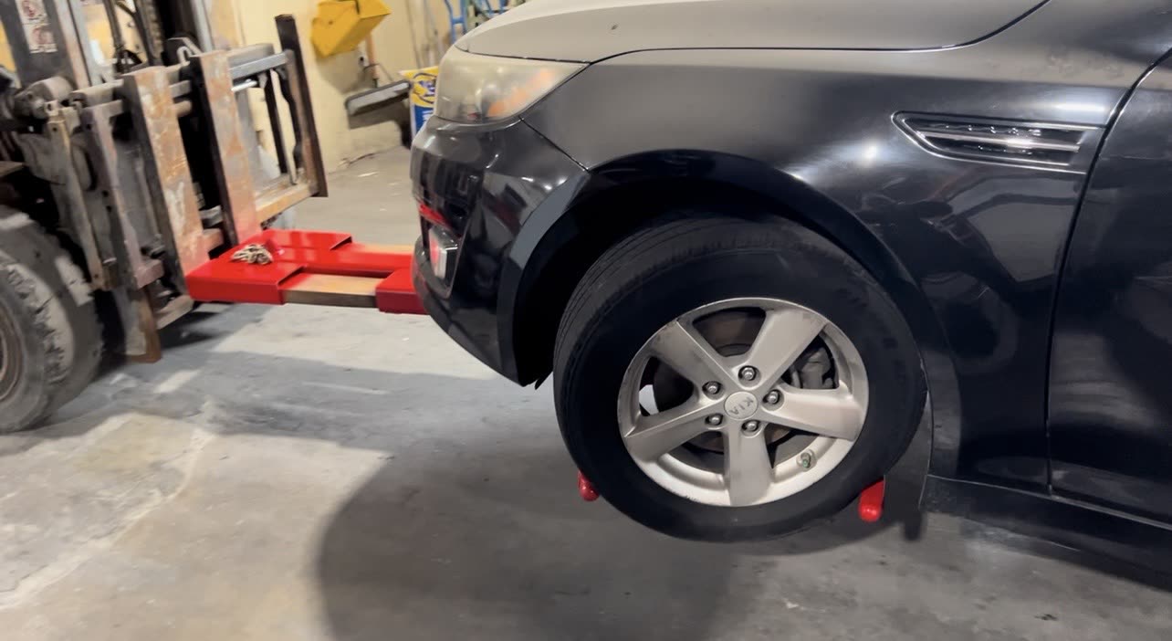 Auto-Hooks pivoted around a car tire, ready to lift