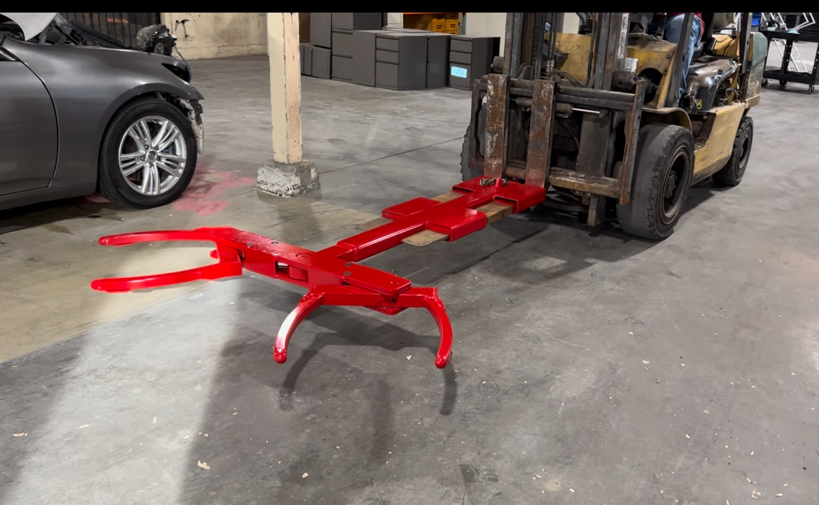 Autowlift attachment mounted on a forklift inside a tow yard, ready to move a vehicle