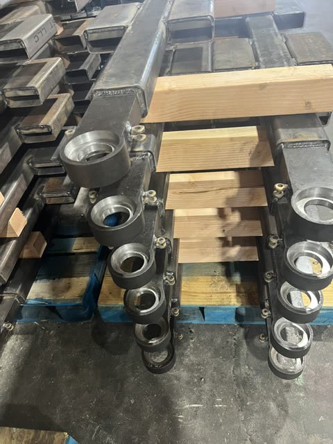 Machined steel bearing housings on Autowlift lift arms before assembly