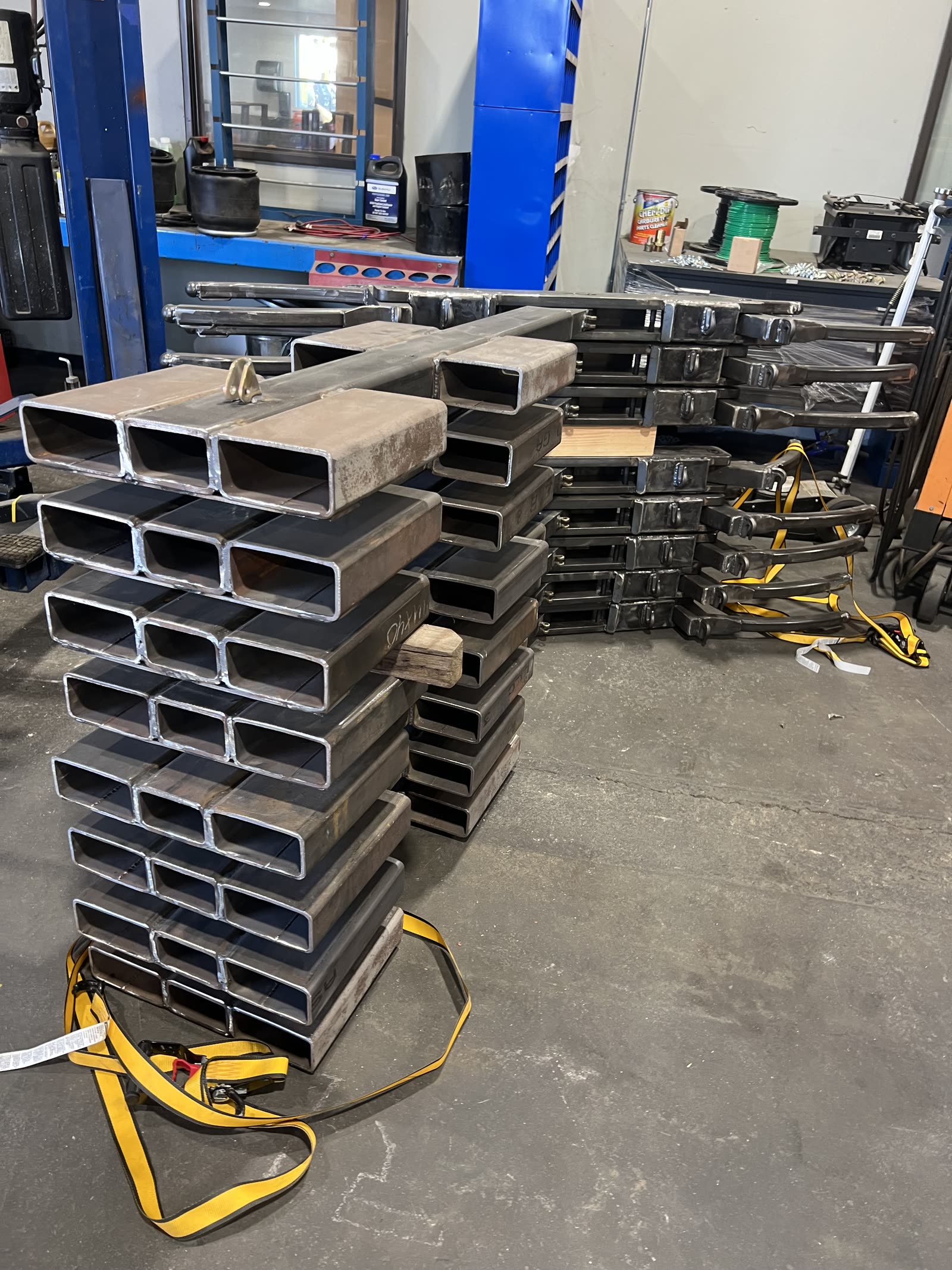 Stacks of heavy-wall steel tube waiting to be cut for Autowlift frames